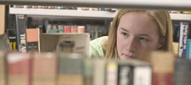 Girl Browsing Books at the Library