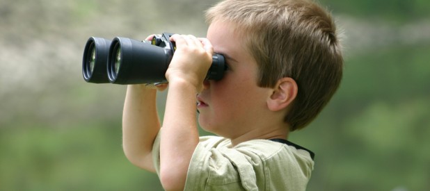 boy looking through binoculars