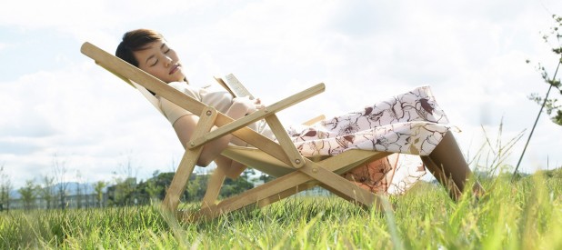 Young Woman Sleeping on Lawn Chair