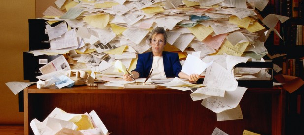 Office Worker with Mountain of Paperwork