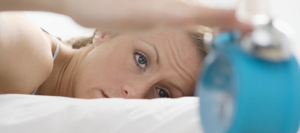 Woman Turning Off Alarm